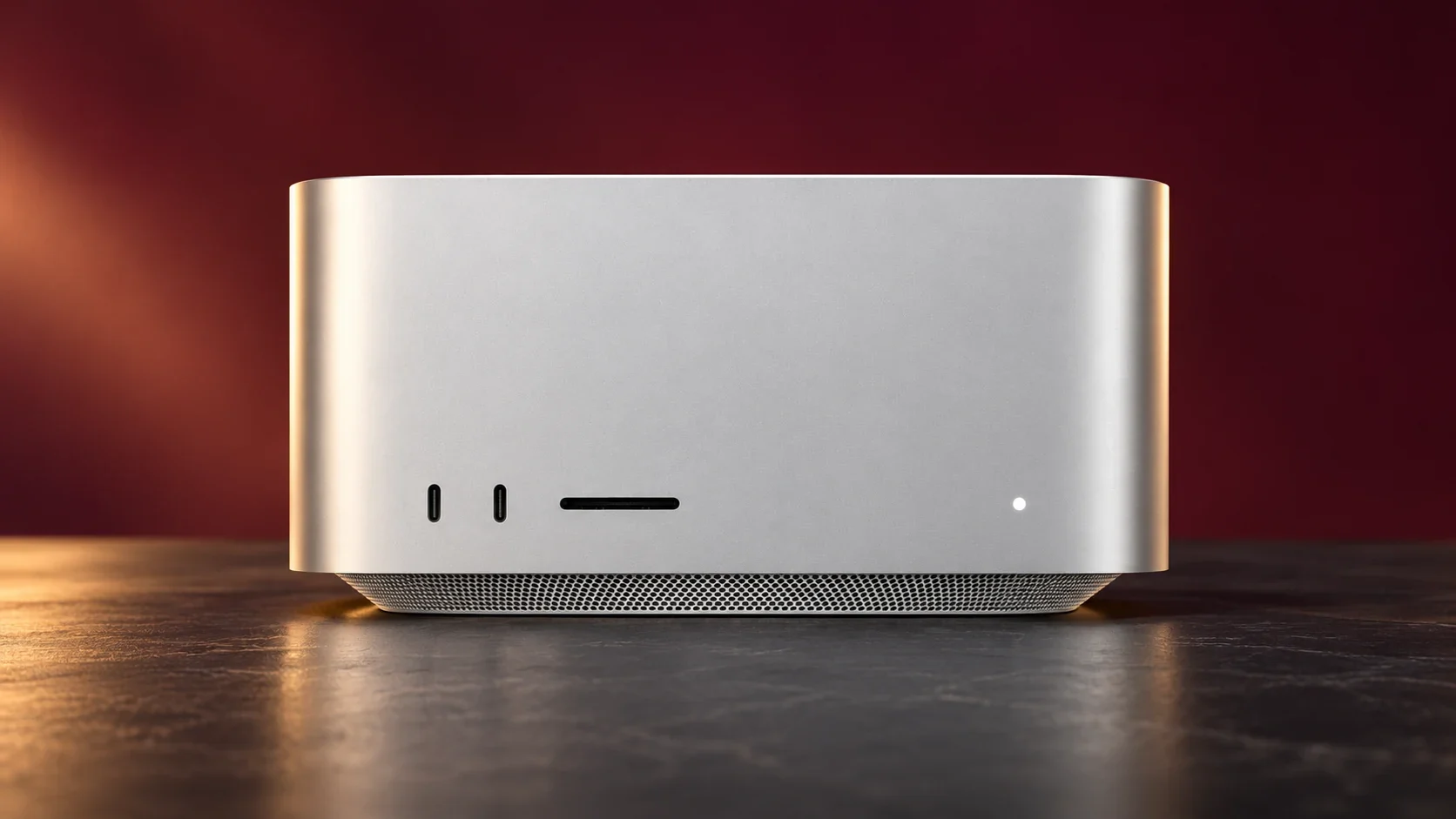 Reference-based editorial illustration of the silver Apple Mac Studio with its front USB-C ports and SD card slot